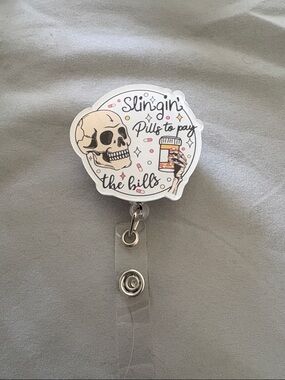 Skull 'Slingin' Pills to Pay the Bills' Badge Reel - White/Pink Accents